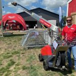 Kolby Woods, of New Standard Ag stands by the Evo Cleaner, a new automated cleaner for livestock barns. Photo: John Greig