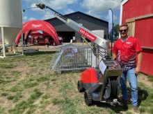Kolby Woods, of New Standard Ag stands by the Evo Cleaner, a new automated cleaner for livestock barns. Photo: John Greig