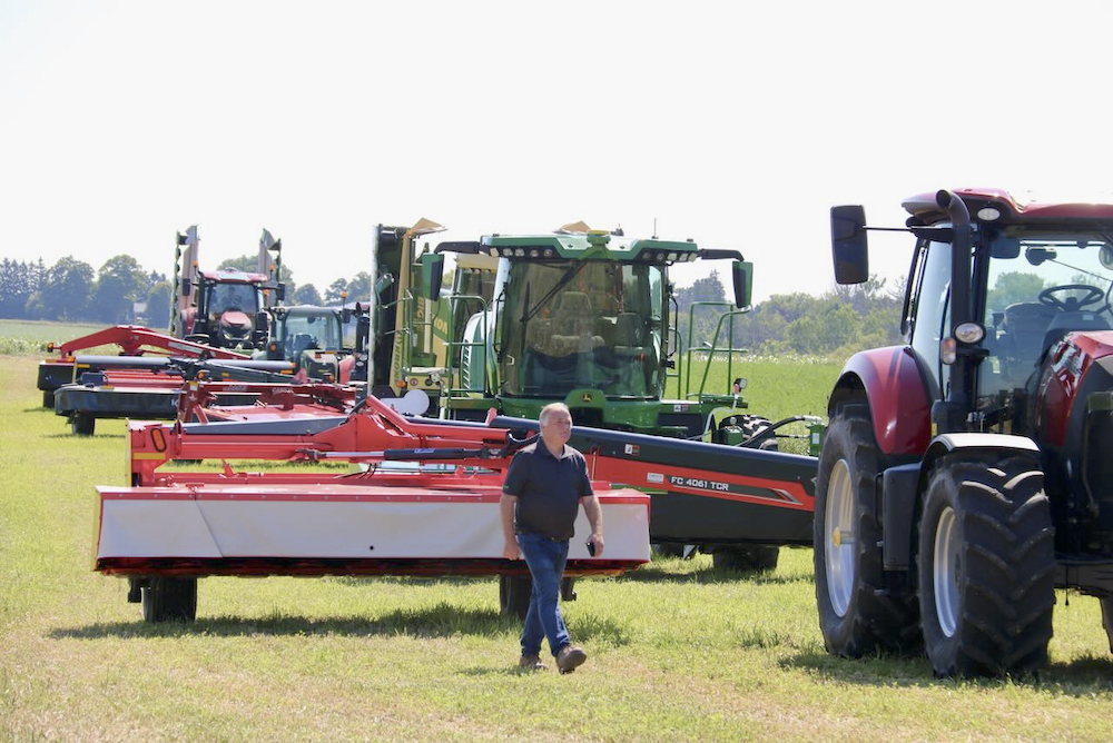 The mowers line up to cut down some hay at the Ontario Forage Expo, western edition, in Gorrie, Ont.