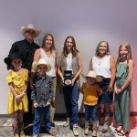 Cassie Marchand (centre) poses with the Schellenberg family, including Reg’s son Coy, daughter-in-law Laura-Lie, wife Shannon and grandchildren Ella, Nora, Ty and Faye. Photo: Canadian Cattle Association