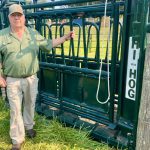 Myron Wigness stands with Hi-Hog squeeze unit at Canada's Outdoor Farm Show.