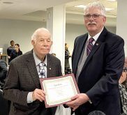 Ontario Sheep Farmers chair, Art Alblas, right, presents  Bill Duffield, left,  and wife Lynne, not pictured, of Codon Suffolks, with top spot for the terminal category during the annual gala event in Cambridge, Oct. 25, 2024.