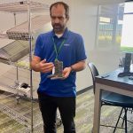 Judd Maxwell, Syngenta's head of North American Corn Product Placement, shows a model of the stock crusher used by the company to automatically measure standability of corn.
