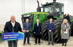 Rob Flack, Minister of Agriculture, Food and Agribusiness, left, flanked by ag-sector representatives, announces a $100 million increase to the Risk Management Program over three years. Photo by Kristy Nudds