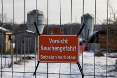 FILE PHOTO: A sign with the inscription  &#8220;Beware of epidemic danger! No trespassing!&#8221; hangs on a fence in front of a farm in Mehrow, close to Ahrensfelde, Germany, January 13, 2025.    REUTERS/Axel Schmidt/File Photo
