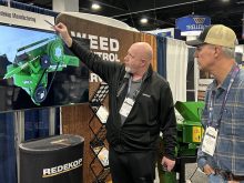 Trevor Thiessen of Redekop Manufacturing explains the company’s straw chopper to a farmer from Oregon at the Commodity Classic in Denver, Colorado, March 4. Redekop and other Canadian manufacturers are adjusting to 25 per cent tariffs on goods exported to the United States. | Robert Arnason photo