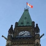 A Canadian flag flies at the top of one of the Parliament buildings in Ottawa.