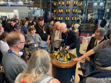 James Duke, founder of ADF Milking, demonstrates the company’s automatic dipping and flushing system to a group of Ontario dairy farmers at EuroTier.