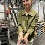 Kristina Alme Gardli, product development lead with Obiochar in Norway shows the company's biochar product which is being used to enhance animal and soil health. Photo: Lilian Schaer