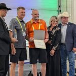 PhiBer Manufacturing won the AgTech innovation award for its drone carrier at the Ag in Motion innovation program, with Saskatchewan Minister of Agriculture Daryl Harrison, right, presenting the award. Photo: Jonah Grignon