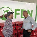 Nigel Buffone, left, Farmers Business Network’s senior director of crop protection, talks to Breen Neeser, FBN’s general manager, at the Ag in Motion show in Langham, Sask. Photo: Sean