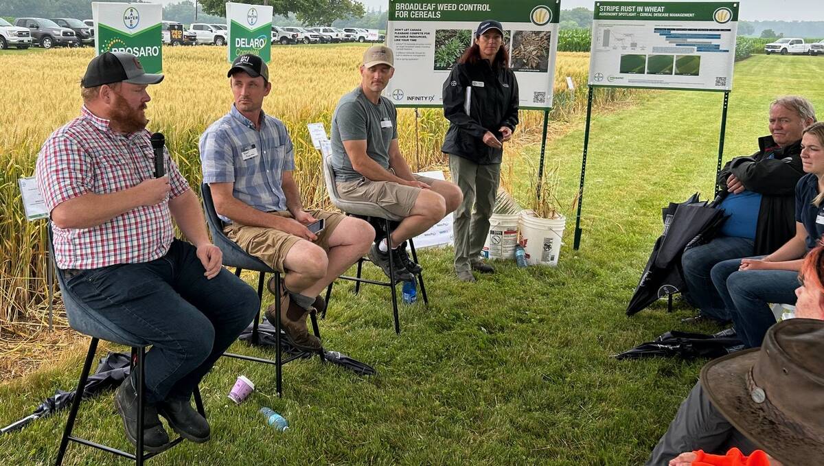 Speaking during a panel discussion hosted by Bayer during its recent “It’s Grow Time” research plot tour near Tavistock are Great Lakes Yield Enhancement Network (YEN) participants, from left: Adam Ireland of Teeswater, Blair Freeman of Owen Sound and Jeff Cook of Talbotville. Photo: Stew Slater
