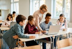 Students and teacher with computer. Photo: Photo: Drazen Zigic/iStock/Getty Images