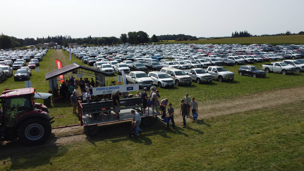 One of the parking areas and shuttle and people movers at  Canada's Outdoor Farm Show. 
