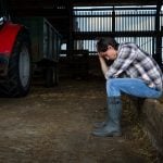 Photo of farmer who seems depressed or distraught. Photo: SolStock/istock/getty images