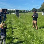Farmers listen to the grazing demonstration at Canda's Outdoor Farm Show.