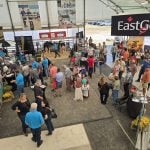 Producers gath in the Dairy Innovations Centre at the 2025 Canada's Outdoor Farm Show for the unveiling of EastGen’s refreshed brand identity while enjoying a complimentary customer appreciation lunch.
