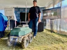 Tanya Franklin, of Upside Robotics, stands with one of the company's fertilizer robots at Canada's Outdoor Farm Show 2025. Photo: John Greig