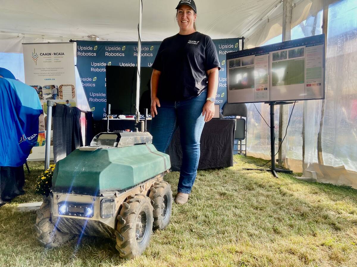 Tanya Franklin, of Upside Robotics, stands with one of the company's fertilizer robots at Canada's Outdoor Farm Show 2025. Photo: John Greig