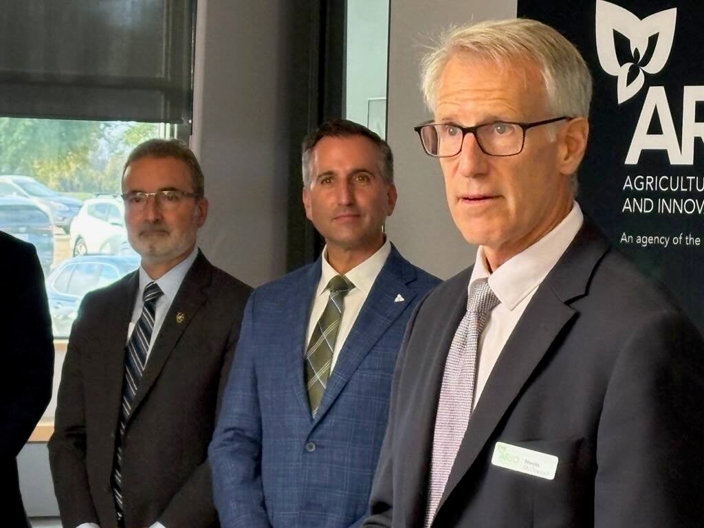 Nevin McDougall, left, of ARIO, listens at the OMAFA announcement of new funding for ARIO on Oct. 7. Also shown are Trevor Jones, Ontario's minister of Agriculture, Food and Agribusiness, centre, and Rene Van Acker, president of the University of Guelph. Photo: Diana Martin
