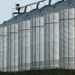A row of six large grain bins. Photo: file
