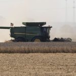 Heat waves are seen on an unusually warm September day as a farmer unloads his combine hopper into a waiting wagon as he harvests a soybean field in western Iowa in rural Woodbury County, Monday, September 29, 2025. Photo: Jerry Mennenga/ZUMA Press Wire