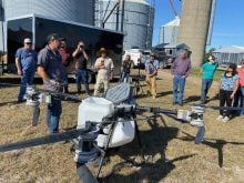 Adrian Rivard talks to attendees of a cover drop seeding demonstration near Embro. Photo: John Greig