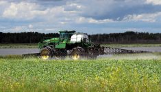 Tractor and sprayer in soybean field