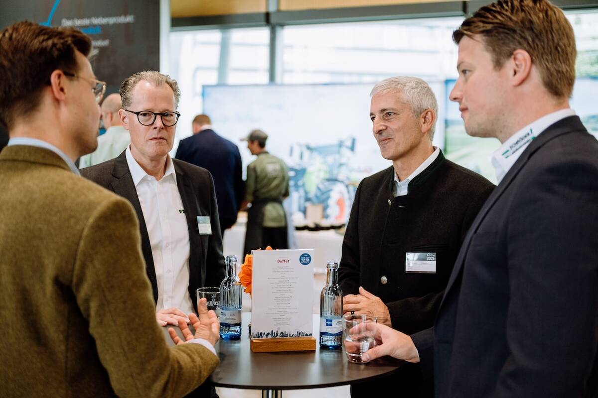 Agco chief executive officer Eric Hansotia, centre, speaks with guests at the company’s Tech Day in Germany.