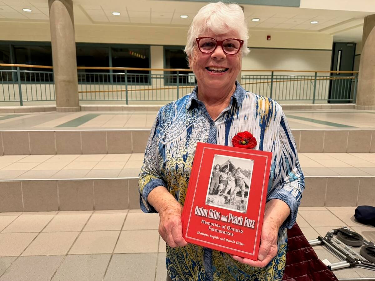 Bonnie Setter holding her book 'Onion skins and peach fuzz' at a screening of the We Lend a Hand documentary in Strathroy, Ont. Photo: John Greig 