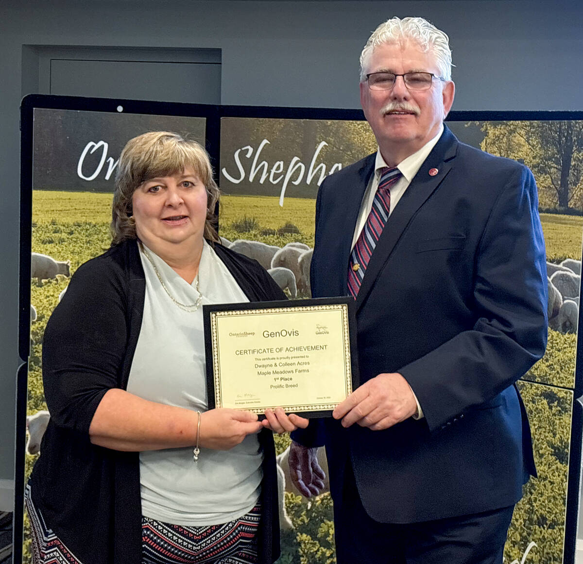 Colleen Acres accepts the GenOvis Prolific Breed award on behalf of herself and Dwayne Bazinet from Art Alblas, Ontario Sheep Farmers chair, during their annual general meeting on Oct. 30, 2025 in Cambridge. Photo: Diana Martin