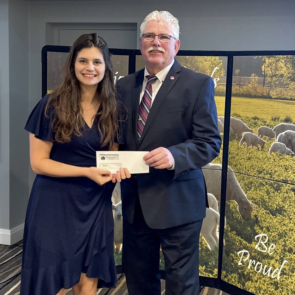 Diana Lucarelli accepts the $500 Memorial Fund Industry Leader Award from Art Alblas, Ontario Sheep Farmers chair,  during their annual general meeting on Oct. 30, 2025 in Cambridge. Photo: Diana Martin