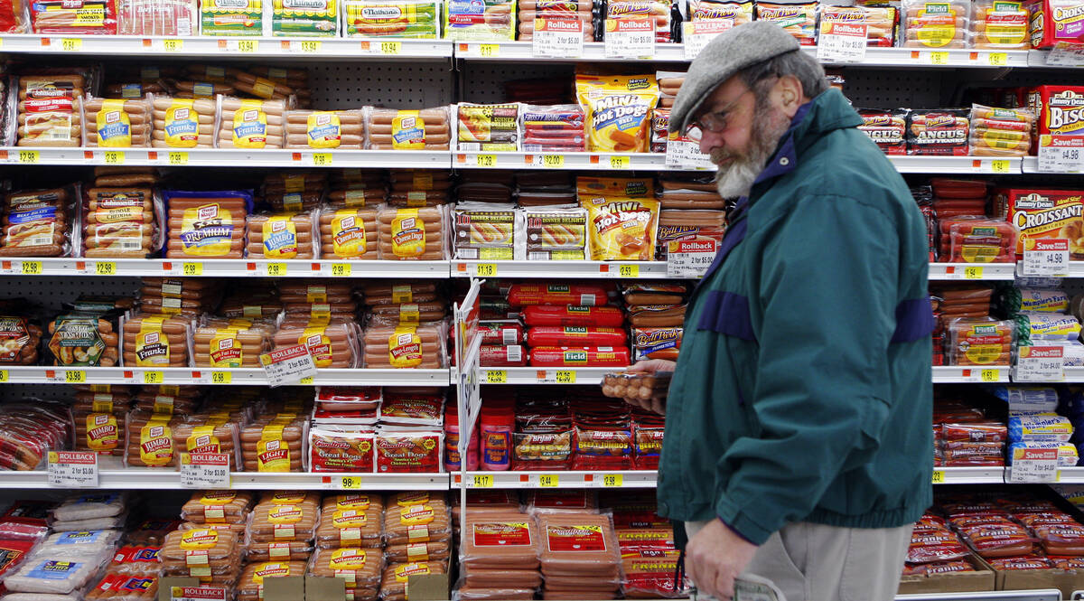 Michael Lipsitz picks out a package of hot dogs while grocery shopping at the WalMart in Crossville, Tennessee March 21, 2008. Food prices are soaring, a wealthier Asia is demanding better food and farmers can?t keep up. In short, the world is in a food crisis that is in danger of boiling over.