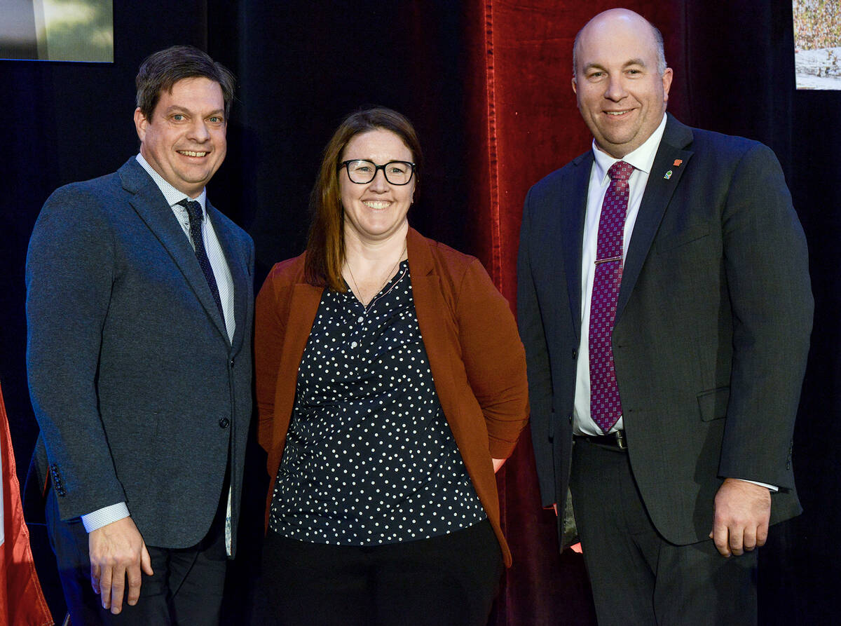 Greg Hannam, left, and Drew Spoelstra, Ontario Federation of Agriculture president, present Lyndsay Dykeman with the inaugural Peter Hannam Leadership Award at the organization's annual general meeting in Toronto on Nov. 25, 2025. Photo: Diana Martin