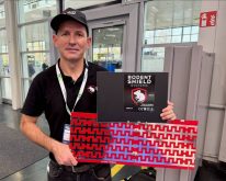 Padraic George shows the fence system he developed to keep rodents out of combines. Photo: John Greig
