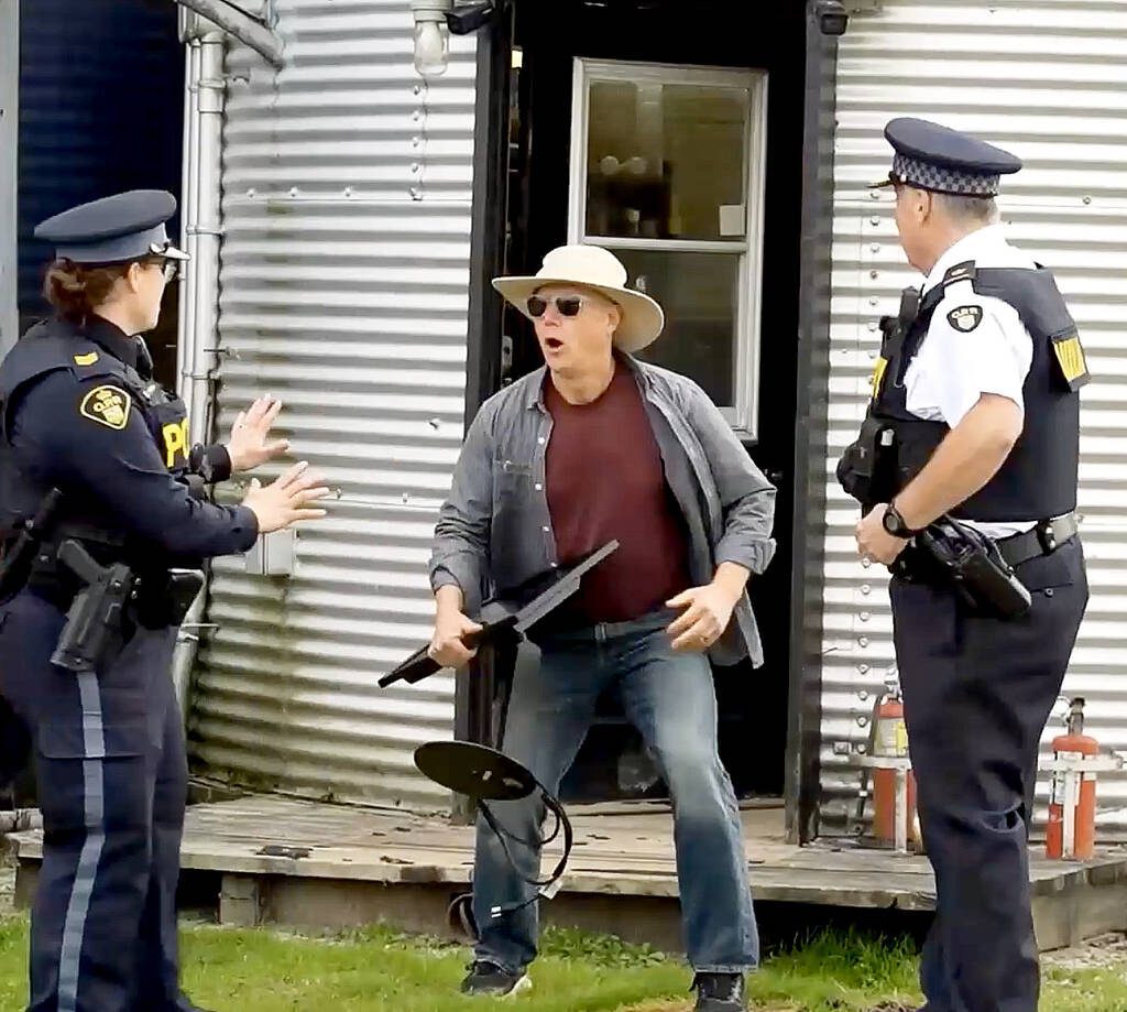 Sgt. Jill Johnson of OPP West Region&rsquo;s Crime Prevention and Community Support Bureau, left,  and Auxiliary Inspector Brad Hull, OPP West Region regional commander, right, catch a "thief" in the act during an OPP video discussing various steps rural property owners can take to protect their property as part of the Grey Bruce Farmers Week On-Demand session in early January.  Screengrab Image. 