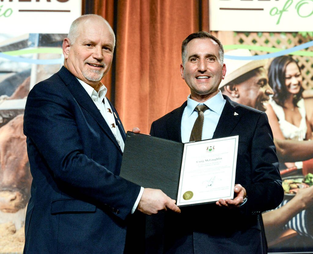 Trevor Jones, Ontario Minister of Agriculture, Food and Agri-business, right, presents Craig McLaughlin, outgoing president of Beef Farmers of Ontario,  left, with a certificate recognizing his contributions to the sector at BFO's annual general meeting gala in Toronto on Feb. 18, 2026. Photo: Diana Martin


