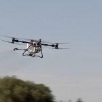 The DJI Agras T100 drone flies through the air during a demonstration at Canada’s Outdoor Farm Show in Woodstock, Ont. Photo: Greg Berg
