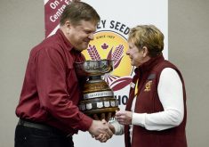 Bruce Hudson, left, presents Kathy Hardy, right, with the 2026 Ottawa Valley Seed Growers Association's Award of Excellence on March 11 at the Ottawa Valley Farm Show. Photo: Diana Martin