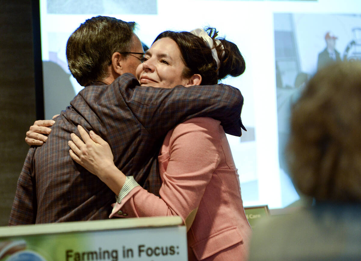 Tonya Haverkamp, right, gets a celebratory hug from John Taylor, after being recognized as the 2026 Farm and Food Care Ontario Champion, on April 9 at the Farm and Food Care annual conference in Wellington County. Photo: Diana Martin